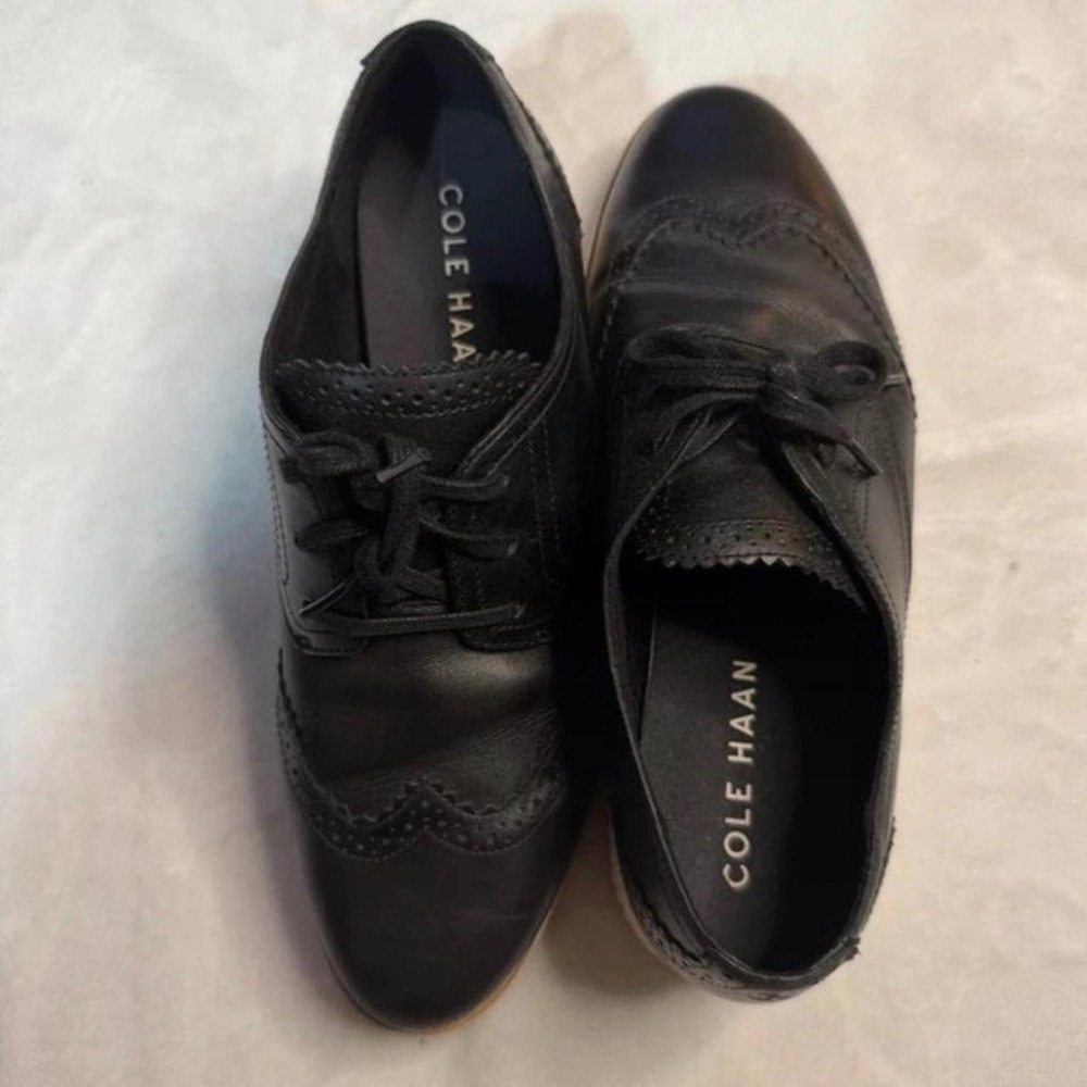 Cole Haan black leather brogue oxfords with lace-up design and pointed toe